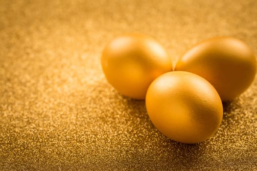 Golden eggs on golden background for Easter