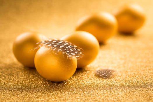 Golden eggs on golden background for Easter