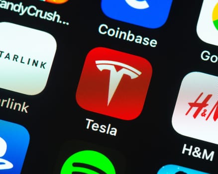 BAYONNE, FRANCE - CIRCA JANUARY 2021: Tesla app icon on Apple iPhone screen. The app is used to control and remotely monitor Tesla products.