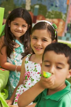 Three children at a birthday party in a park