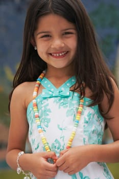 Portrait of a girl wearing a candy necklace and smiling