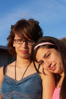 Portrait of a girl leaning on a teenage girl's shoulder
