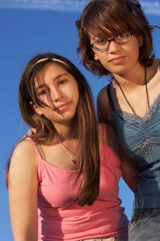Low angle view of a teenage girl standing with her sister