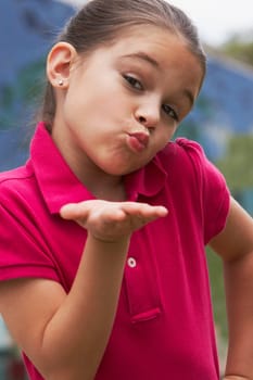 Portrait of a girl blowing kisses