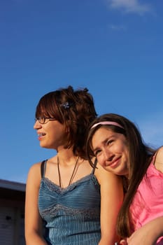 Close-up of a girl leaning on a teenage girl's shoulder