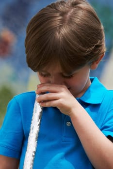 Close-up of a boy looking through a rod
