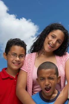 Portrait of two boys and a teenage girl smiling
