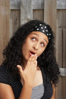 Close-up of a teenage girl looking up in surprise