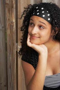 Close-up of a teenage girl thinking with her hand on her chin
