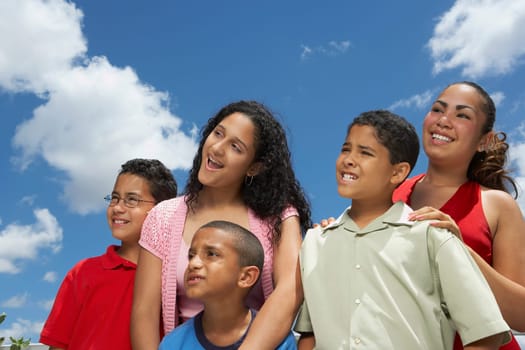 Close-up of three boys and two teenage girls smiling