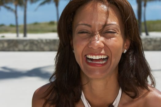 Portrait of a mature woman laughing on the beach, South Beach, Miami Beach, Florida, USA