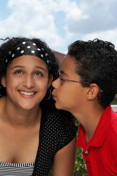 Side profile of a boy kissing a teenage girl