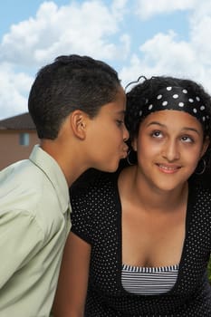Side profile of a boy kissing a teenage girl