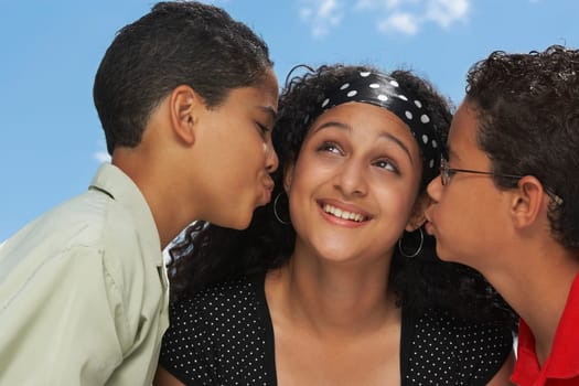 Side profile of two boys kissing a teenage girl