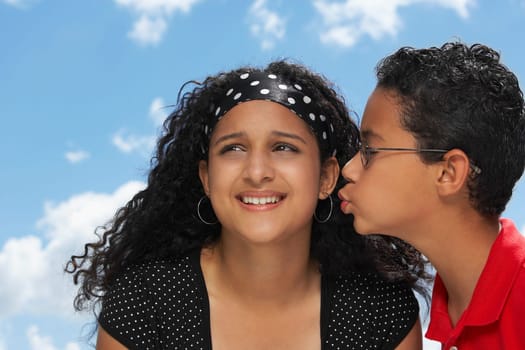 Side profile of a boy kissing a teenage girl