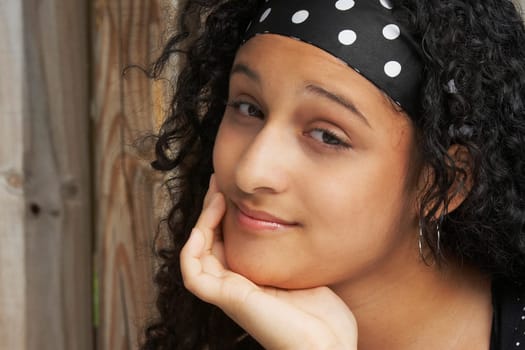 Portrait of a teenage girl thinking with her hand on her chin