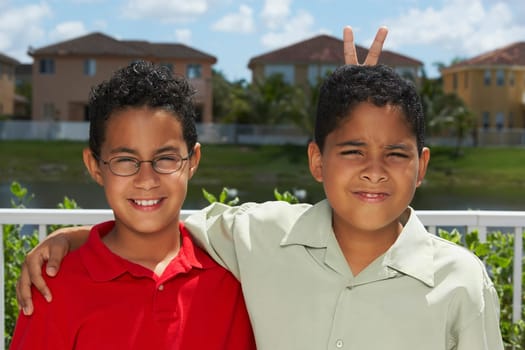 Portrait of a boy making a gesture of rabbit ears behind another boy's head