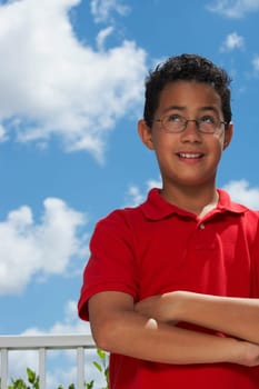 Close-up of a boy with his arms crossed