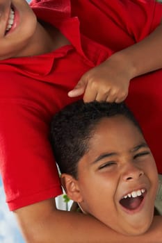 Close-up of a boy pulling the hair of another boy