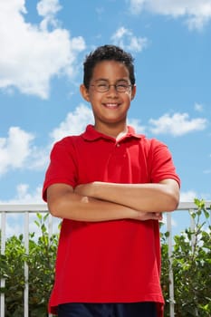 Portrait of a boy standing with his arms crossed