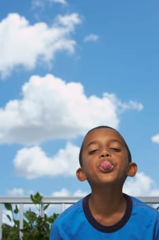 Portrait of a boy sticking his tongue out