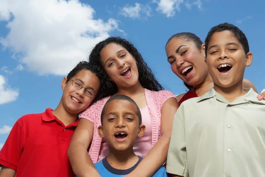 Portrait of two teenage girls and three boys laughing