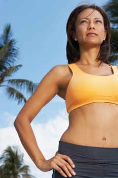 Low angle view of a mature woman standing with her hand on her hip