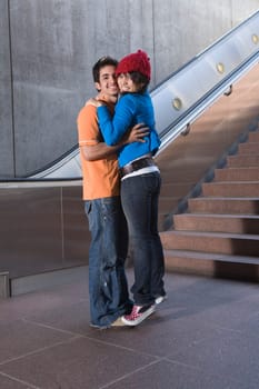 Portrait of a young couple embracing each other and smiling