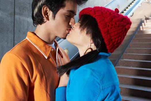 Side profile of a young couple kissing each other