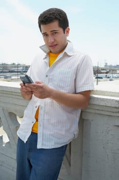 Portrait of a young man using a personal data assistant