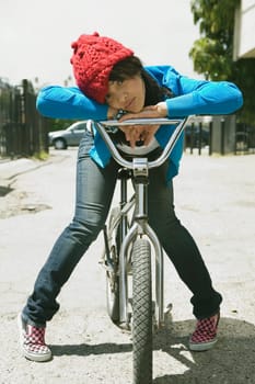 Portrait of a young woman sitting on a bicycle