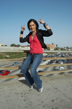 Portrait of a young woman standing on her toe and gesturing