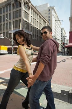 Young couple salsa dancing on the road