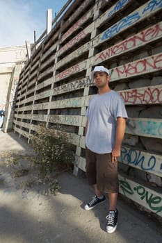 Young man standing in front of a wall