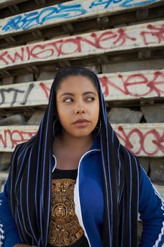 Close-up of a young woman covering her head with a scarf