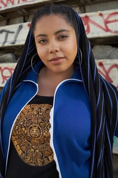 Portrait of a young woman covering her head with a scarf