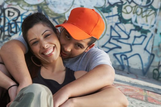 Portrait of a young man embracing a young woman from behind