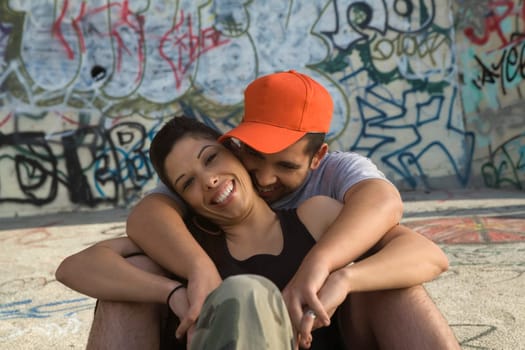Young man embracing a young woman from behind