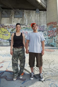 Portrait of a young couple holding each other's hand and smiling