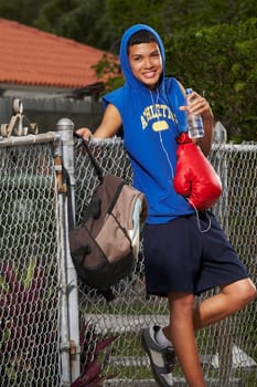Portrait of a teenage boy listening ipod and smiling