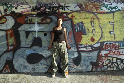 Young woman leaning against a wall