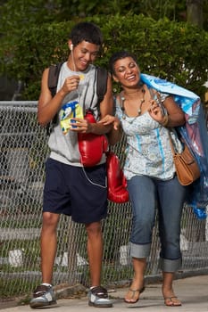 Teenage boy and his sister walking on the walkway