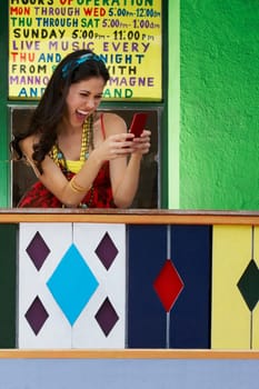 Young woman text messaging on a mobile phone