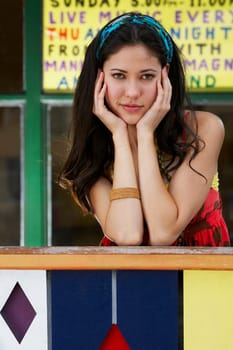 Portrait of a young woman leaning on a railing