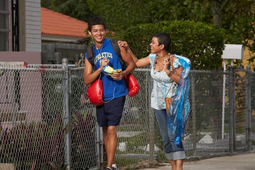 Teenage boy and his sister walking on the walkway
