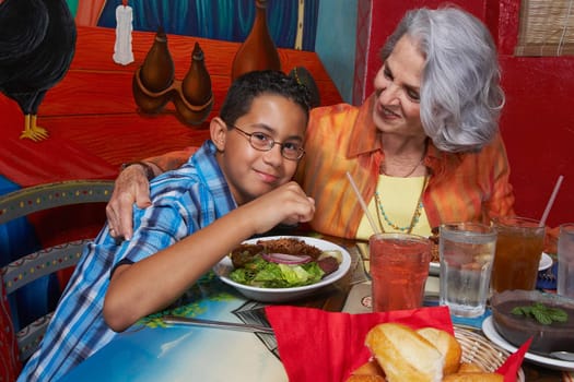 Close-up of a boy with his grandmother in a restaurant