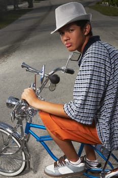 Portrait of a teenage boy cycling on a low rider bicycle