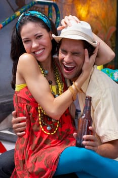 Close-up of a young woman sitting on the lap of a young man
