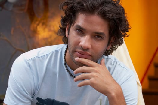Portrait of a young man with his hand on his chin