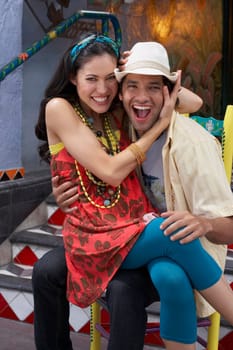 Portrait of a young woman sitting on the lap of a young man